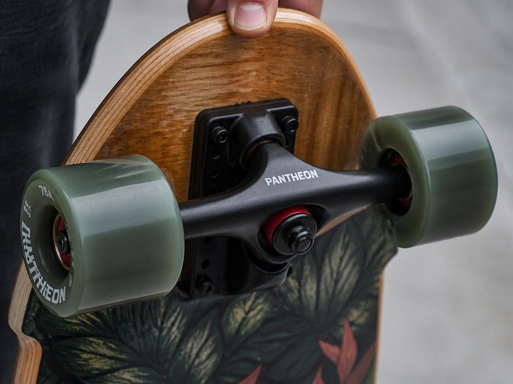 Close-up of a cruiser skateboard's large soft wheels and wide deck for comfortable riding.
