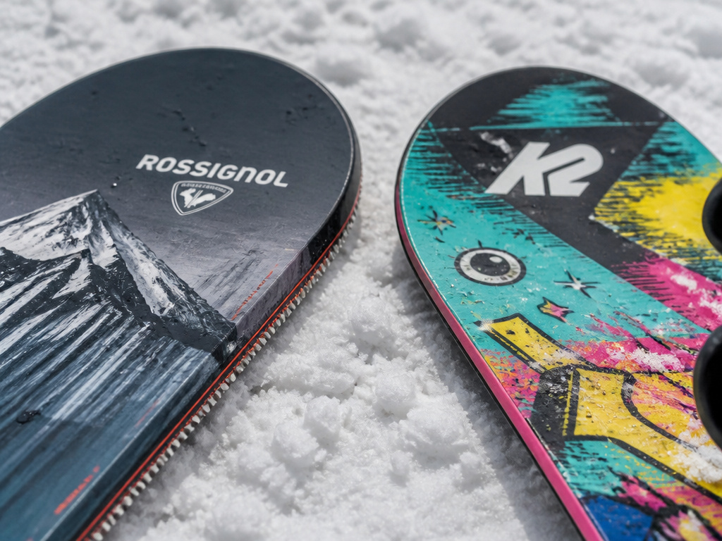 Close-up comparison of Rossignol vs K2 snowboard tips and edges on snow.