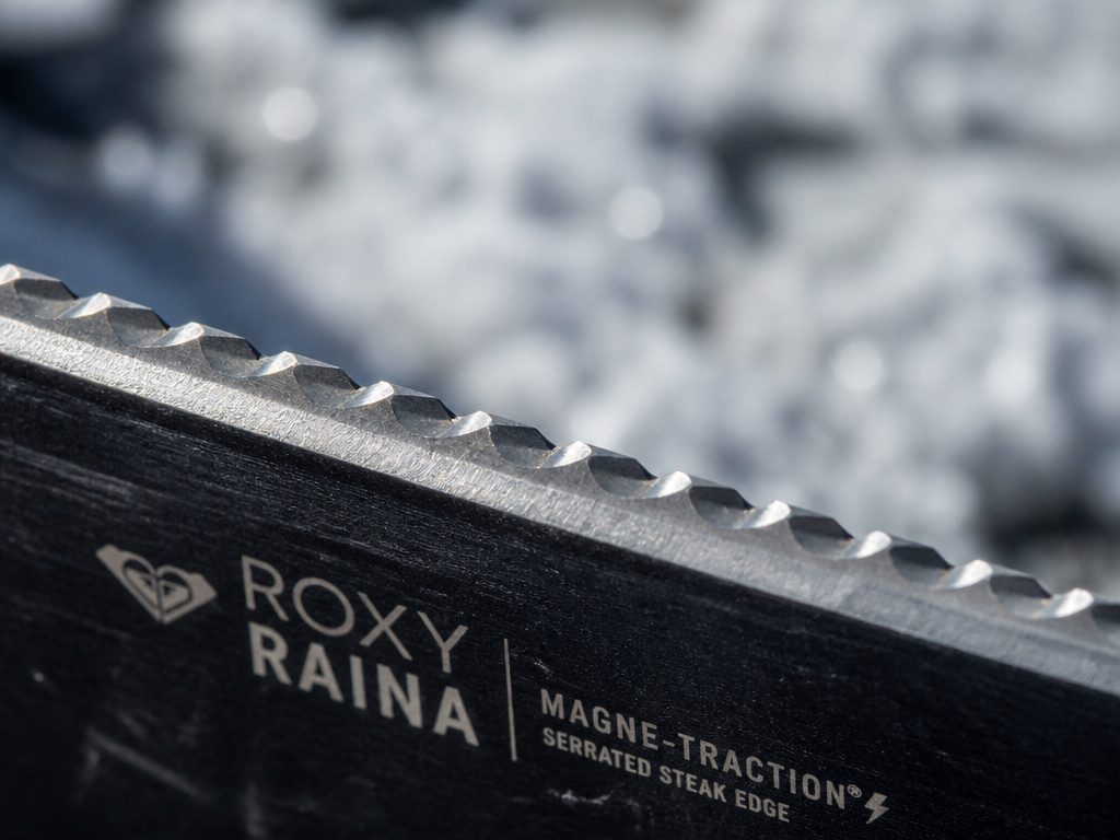 Close-up detail of Roxy Raina snowboard's serrated Magne-Traction edge technology.