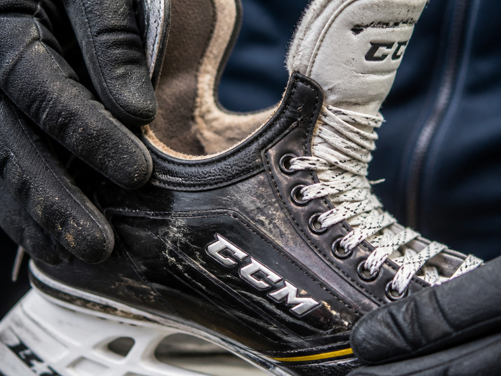 Close-up of worn CCM skate liner, rivets, and high-stress areas for durability review.
