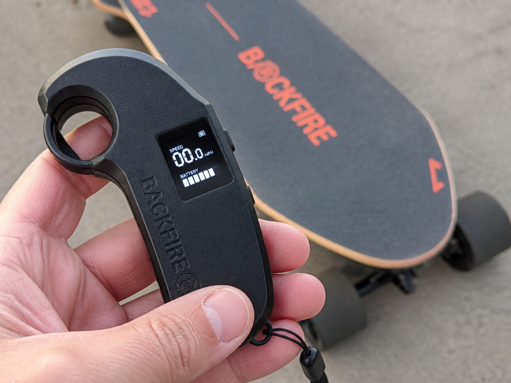 Backfire electric skateboard remote control showing speed and battery display.