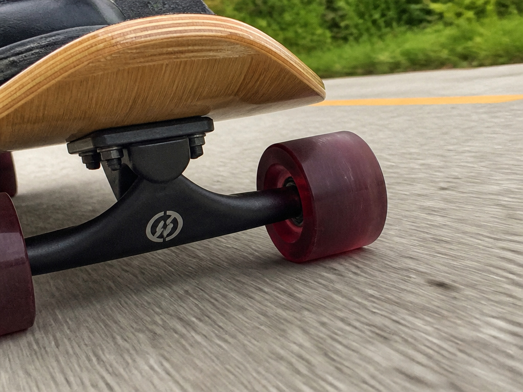 Magneto skateboard cruising on a smooth path, showing bamboo deck and soft wheels