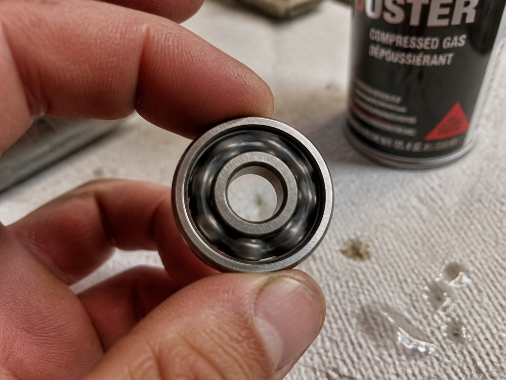 Close-up of spinning a skateboard bearing dry on a paper towel.