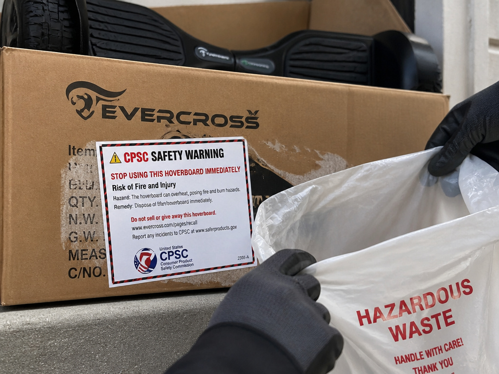 Evercross hoverboard delivery box with CPSC warning label and hazardous waste bag.